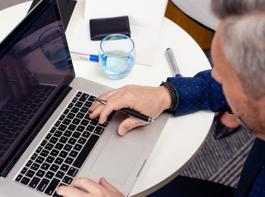 Male professional using a laptop to join online training and webinars from any location.
